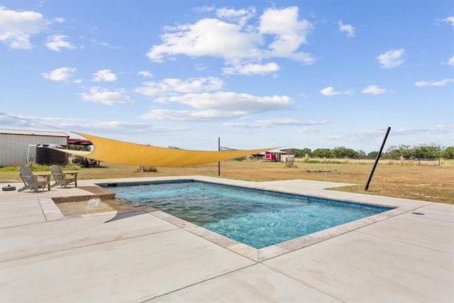 view of swimming pool featuring a lawn and a patio