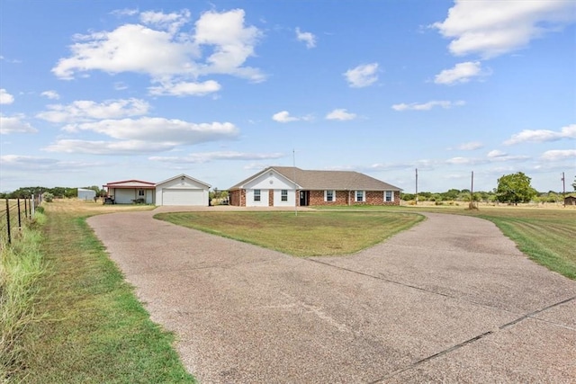 ranch-style home featuring a front yard and a garage