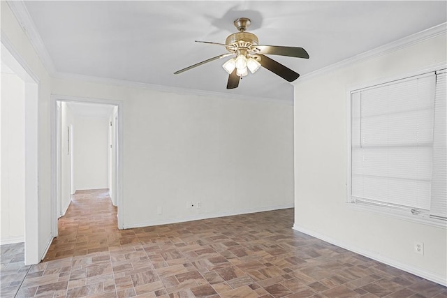 spare room featuring ceiling fan and ornamental molding