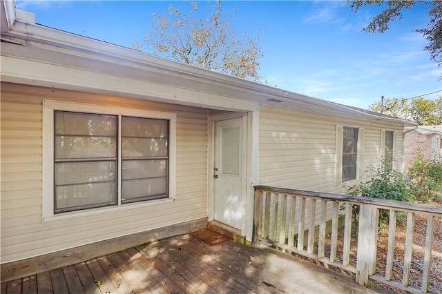 view of exterior entry with a deck