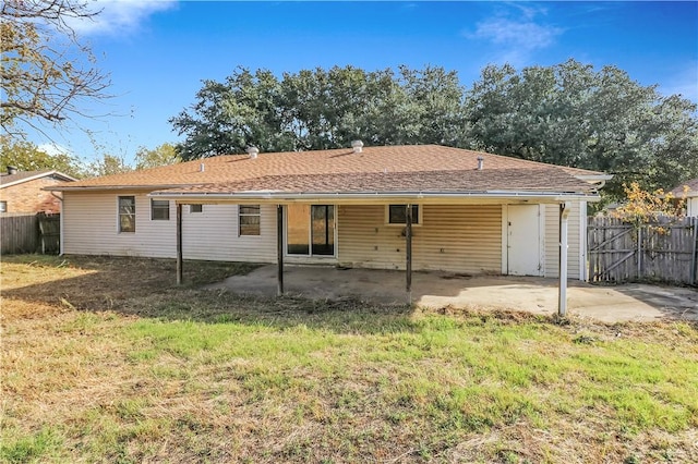 back of property featuring a lawn and a patio