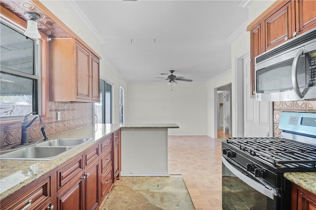 kitchen featuring sink, decorative backsplash, ceiling fan, ornamental molding, and appliances with stainless steel finishes