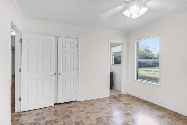 unfurnished bedroom featuring ceiling fan, ornamental molding, and a closet