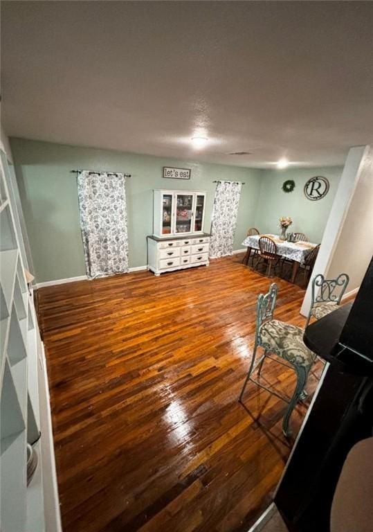 interior space with baseboards and hardwood / wood-style floors