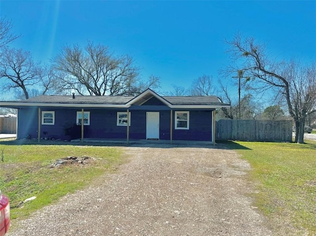 single story home featuring a front yard, fence, and driveway