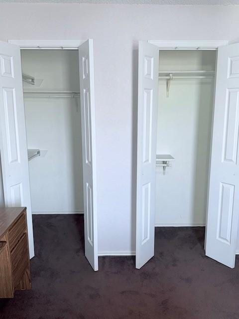 unfurnished bedroom with two closets