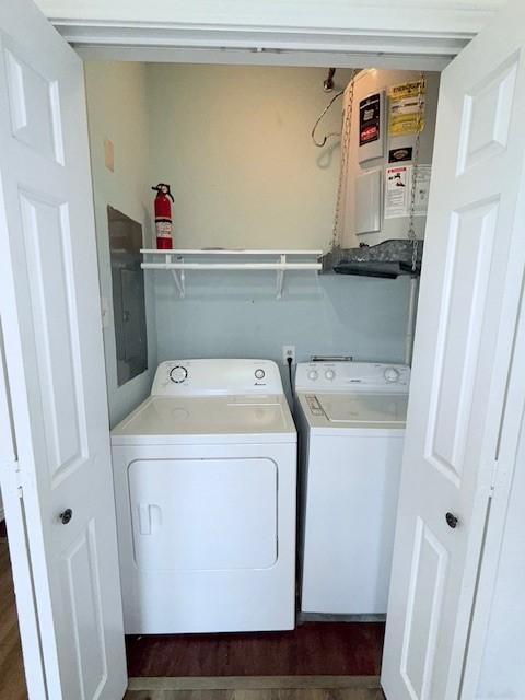 laundry area with separate washer and dryer and dark hardwood / wood-style flooring