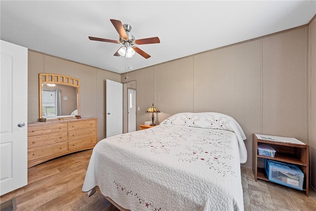 bedroom with ceiling fan and wood-type flooring