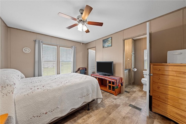 bedroom with ceiling fan and connected bathroom