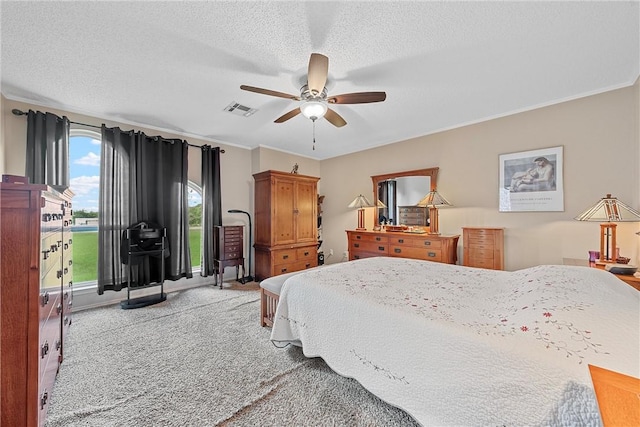 bedroom with a textured ceiling and ceiling fan