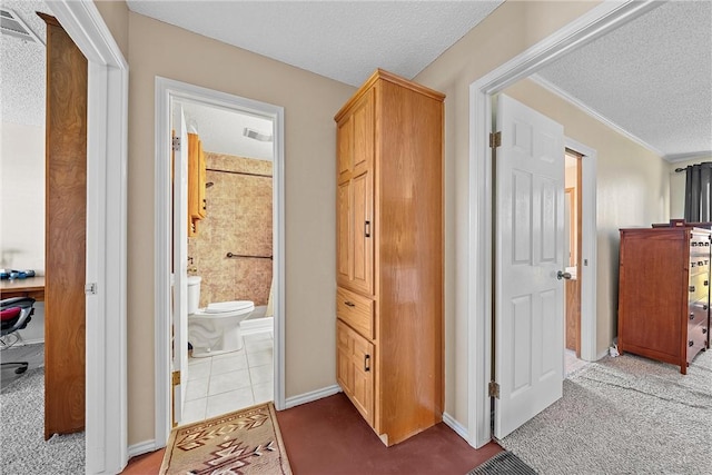 hall featuring carpet flooring and a textured ceiling