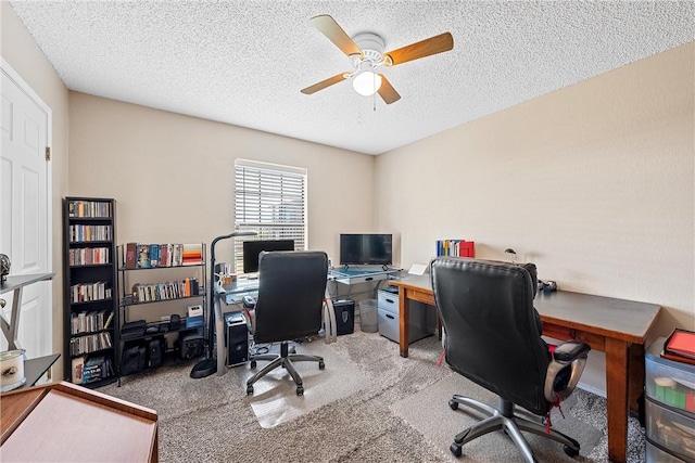 carpeted office space with ceiling fan and a textured ceiling