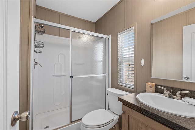 bathroom featuring vanity, toilet, and walk in shower