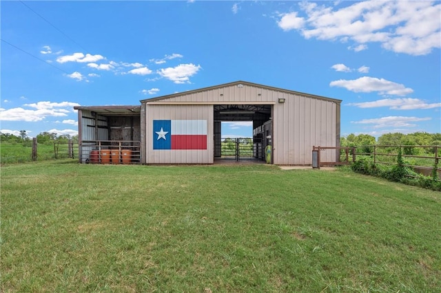 view of outbuilding with a lawn and a rural view