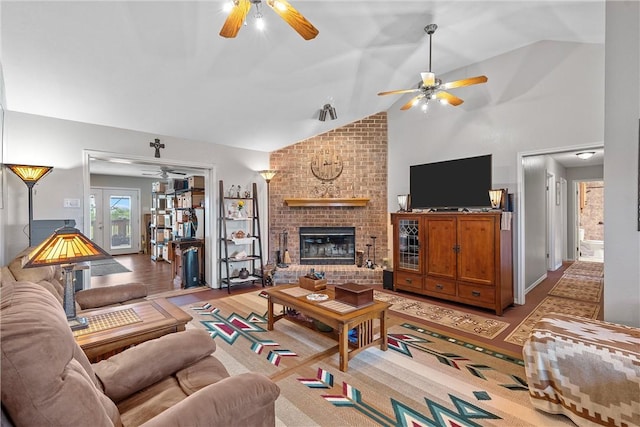 living room with french doors, a fireplace, and vaulted ceiling