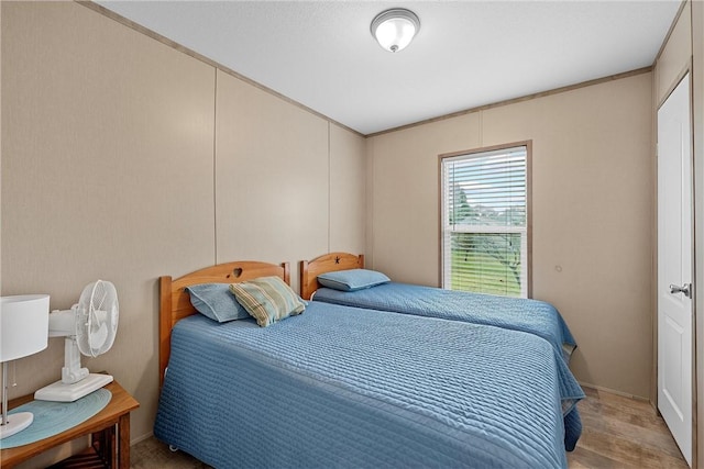 bedroom featuring light hardwood / wood-style floors and ornamental molding