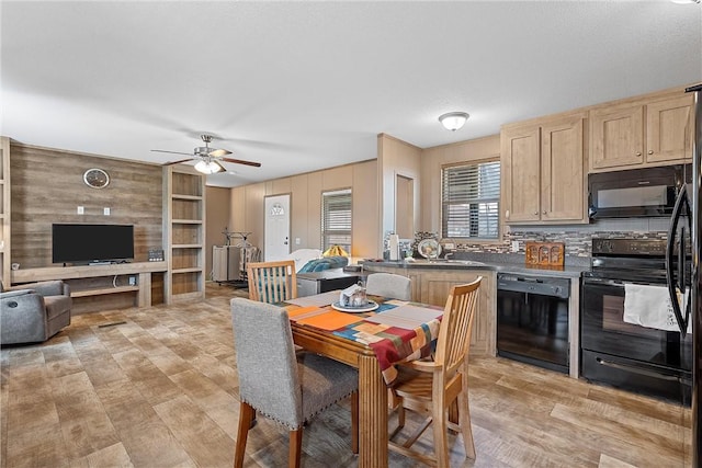 interior space featuring black appliances, sink, light wood-type flooring, light brown cabinetry, and tasteful backsplash