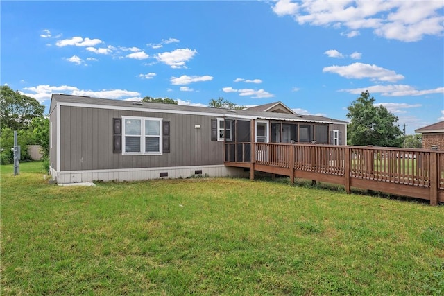 back of house featuring a sunroom, a yard, and a deck