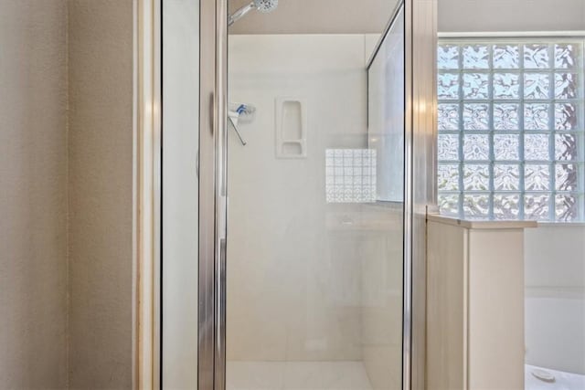 bathroom with a healthy amount of sunlight and walk in shower