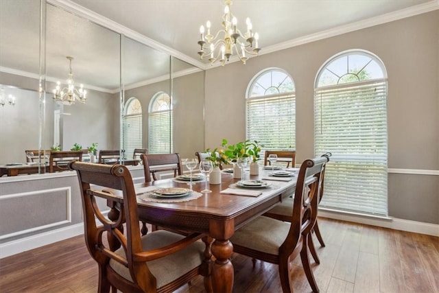 dining area featuring wood-type flooring, an inviting chandelier, and ornamental molding