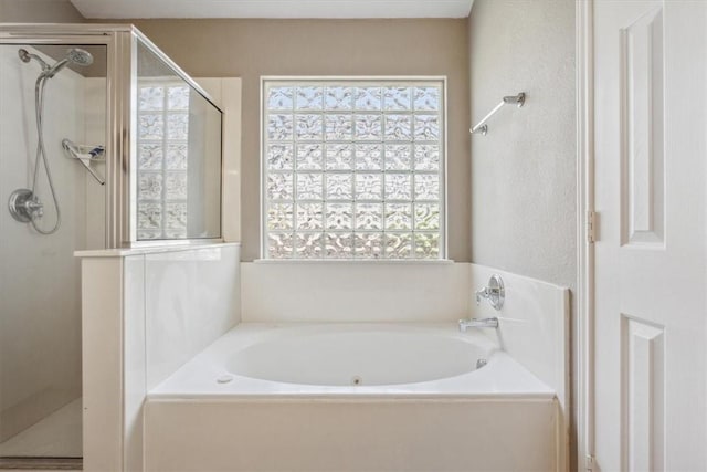 bathroom featuring shower with separate bathtub