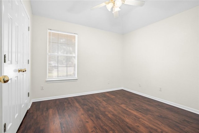 unfurnished room with ceiling fan and dark hardwood / wood-style flooring