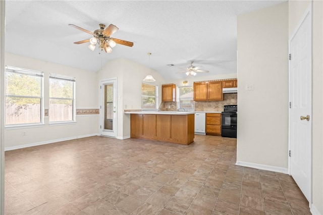 kitchen featuring black electric range, a healthy amount of sunlight, kitchen peninsula, and lofted ceiling