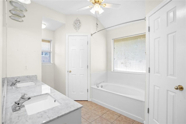 bathroom featuring a bathing tub, ceiling fan, tile patterned flooring, vaulted ceiling, and vanity