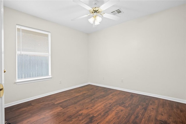 spare room with ceiling fan and dark hardwood / wood-style floors