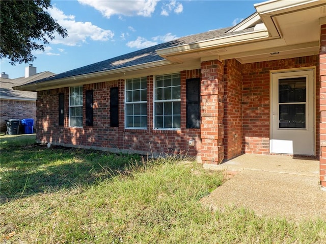 entrance to property with a lawn