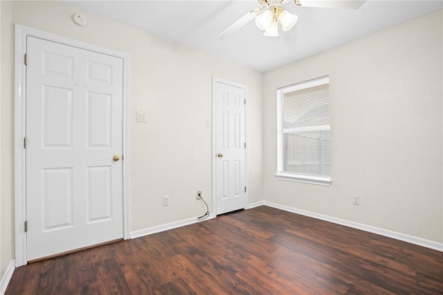 unfurnished room featuring ceiling fan and dark wood-type flooring