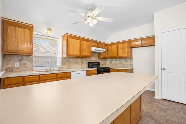 kitchen featuring decorative backsplash, sink, black range oven, and vaulted ceiling