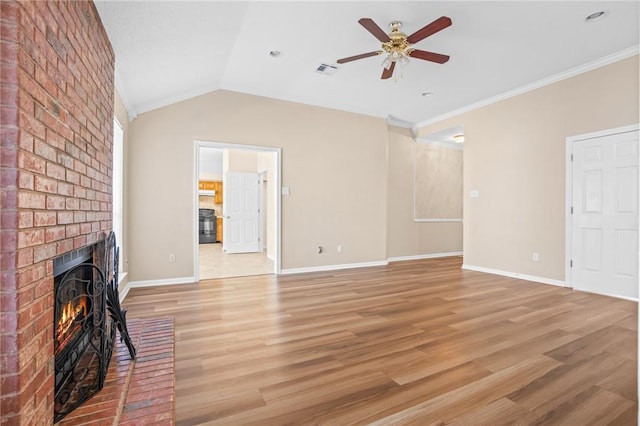 unfurnished living room with vaulted ceiling, ceiling fan, light wood-type flooring, a fireplace, and ornamental molding