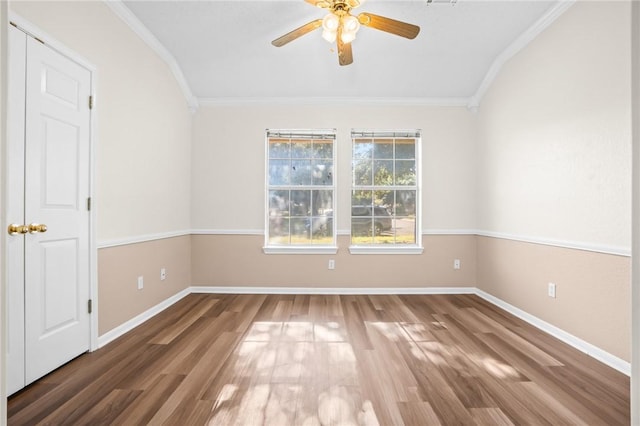 unfurnished room featuring hardwood / wood-style floors, ceiling fan, ornamental molding, and vaulted ceiling