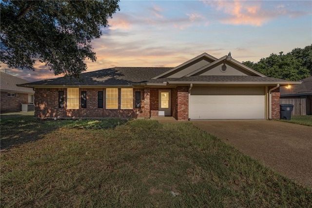 single story home with cooling unit, a garage, and a yard