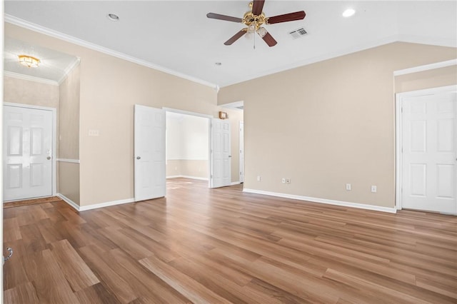 interior space featuring hardwood / wood-style flooring, ceiling fan, crown molding, and vaulted ceiling