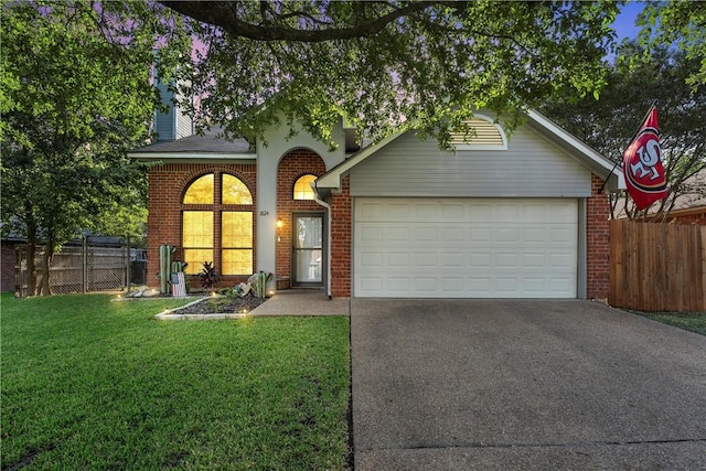 view of front of property with a garage and a front lawn