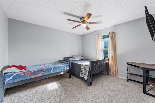 carpeted bedroom featuring a textured ceiling and ceiling fan