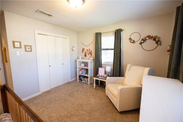 living area featuring visible vents and carpet flooring