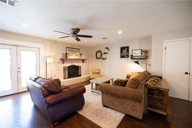 living room with recessed lighting, visible vents, wood finished floors, and a fireplace