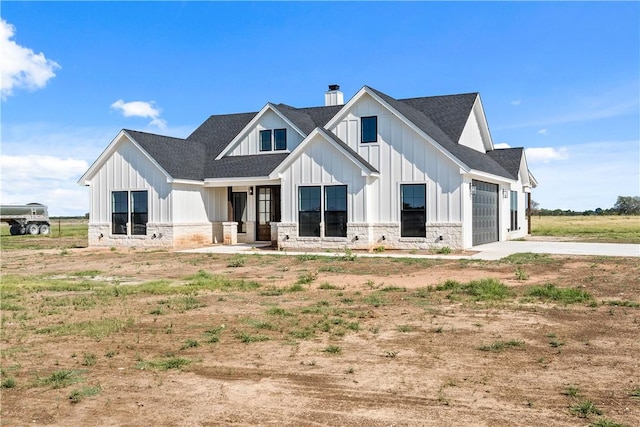 modern inspired farmhouse with a garage