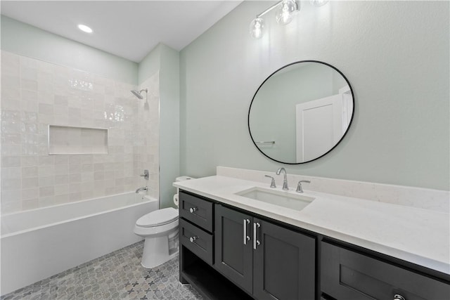 full bathroom with tile patterned flooring, vanity, toilet, and tiled shower / bath