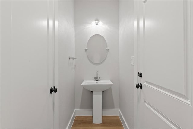 bathroom with wood-type flooring