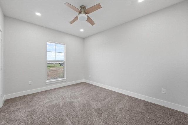 carpeted empty room featuring ceiling fan