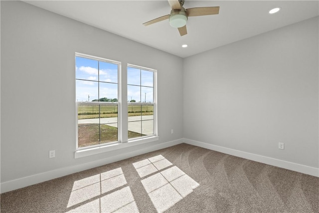 empty room with ceiling fan and carpet floors