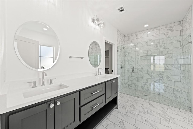 bathroom featuring a tile shower and vanity