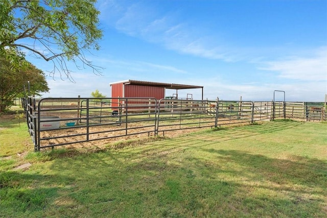 view of yard with a rural view and an outbuilding