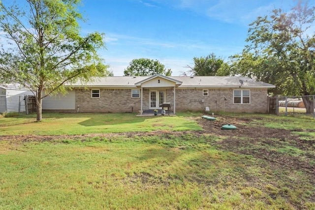 rear view of house featuring a yard