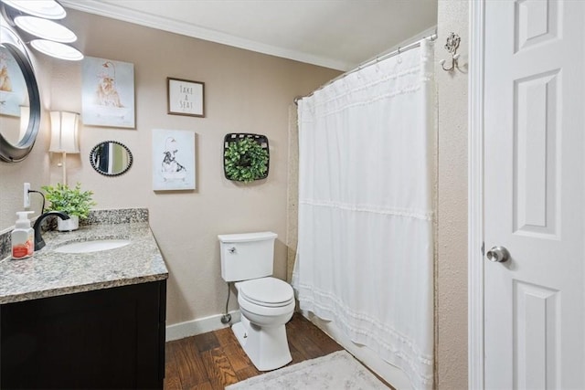 bathroom with hardwood / wood-style floors, vanity, toilet, and ornamental molding