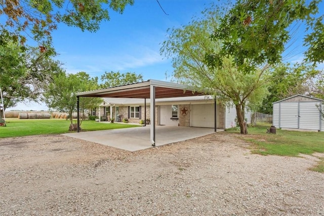 exterior space with a carport, a shed, and a lawn